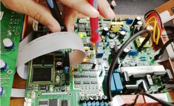 What is the hazard of holding the PCB board with one hand?